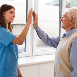 side-view-caregiver-high-fiving-with-old-man_reduced
